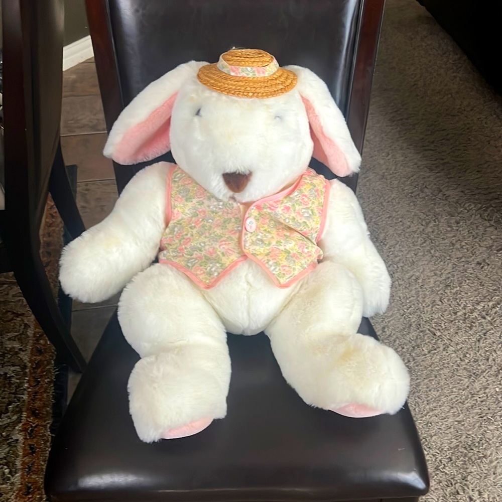 Cute kids bunny stuff animal. Dressed in a floral vest and straw hat.